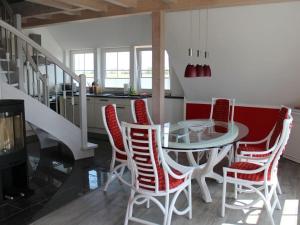 una sala da pranzo con tavolo e sedie in vetro di Holiday apartment with 2 bedrooms a Hof Dranske