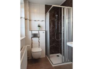 a bathroom with a toilet and a shower at House Nietmann Holiday Apartment No 3 in Altenau +18 photos