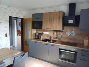 a kitchen with a sink and a stove top oven at House Nietmann Holiday Apartment No 3 in Altenau