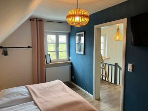 a bedroom with a bed and a blue wall at Holiday home in Ahorntal with swimming pool in Hinterkleebach