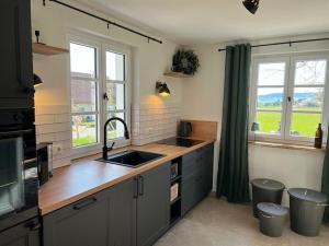 a kitchen with a sink and two windows at Holiday home in Ahorntal with swimming pool in Hinterkleebach +9 photos
