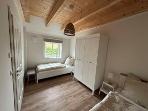 a bedroom with a bed and a window at The Linnebargs, House 1 in Bisdorf