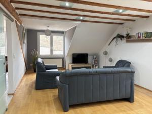a living room with a couch and two chairs at Holiday apartment Ina in Sankt Aldegund