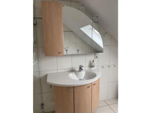 a bathroom with a sink and a mirror at Holiday apartment Ina in Sankt Aldegund +28 photos