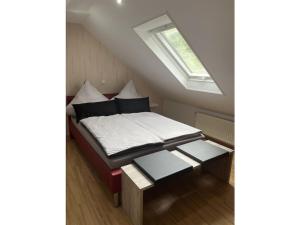 a bed in a small room with a window at Holiday apartment Ina in Sankt Aldegund