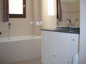 a bathroom with a sink and a bath tub at Holiday apartment in Lumio with swimming pool in Lumio
