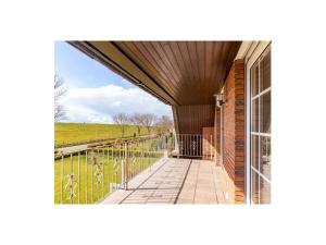 an external view of a building with a balcony at Dream holiday under a thatched roof in Brunsbüttel