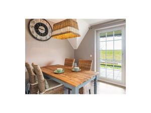 a dining room with a wooden table and a clock at Dream holiday under a thatched roof in Brunsbüttel