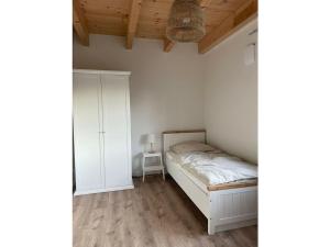 a small bedroom with a bed and a cabinet at The Linnebargs, House 2 in Bisdorf