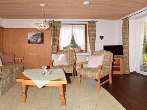 a living room with a couch and a table at Holiday apartment with 2 bedrooms in Akams