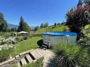 a hot tub in the middle of a garden at Holiday apartment with 2 bedrooms in Akams