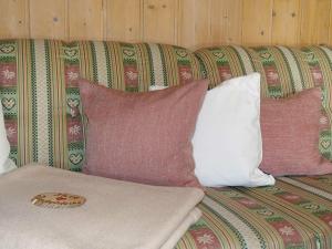 a couch with several pillows on it at Holiday apartment with 2 bedrooms in Akams +24 photos