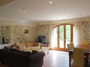 a living room with a couch and a table at Syrah - Domaine La Flotte in Chalabre