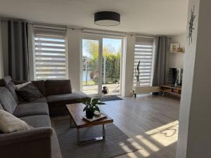 a living room with a couch and a table at Holiday home in Makkum with swimming pool in Holle Poarte