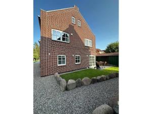 a large brick house with a garden in front of it at The Linnebargs, House 3 in Bisdorf