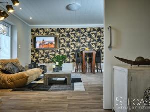 a living room with a couch and a table at Holiday apartment with 1 bedroom in Südrandweg