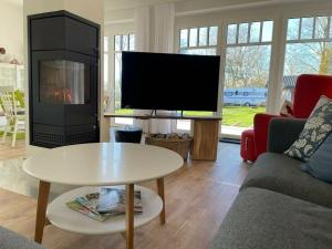 a living room with a tv and a coffee table at The Linnebargs, House 4 in Bisdorf