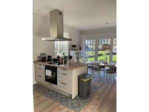 a kitchen with a table and a stove top oven at The Linnebargs, House 4 in Bisdorf