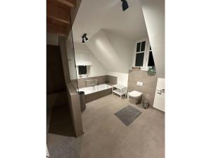 a bathroom with a sink and a bath tub at The Linnebargs, House 4 in Bisdorf +32 photos