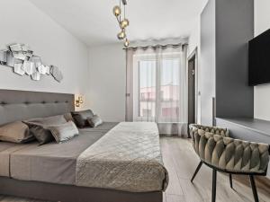 a bedroom with a large bed and a chair at Villa in Medulin with swimming pool in Premantura +33 photos