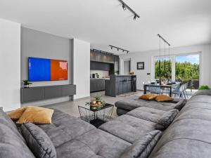 a living room with two couches and a kitchen at Villa in Medulin with swimming pool in Premantura