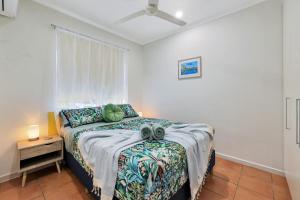 una camera da letto con un letto e una finestra di Ocean Vista Nightcliff Foreshore Apartment a Nightcliff