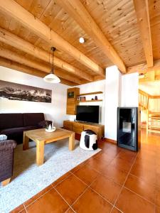 a living room with a couch and a table at Ferienhaus Gollbichl in Sachrang