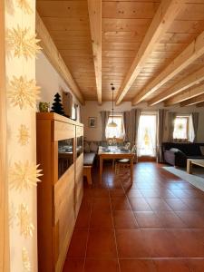 a living room with wooden ceilings and a table at Ferienhaus Gollbichl in Sachrang