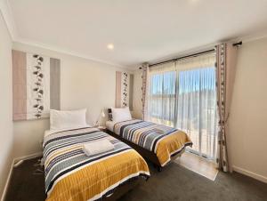 En eller flere senge i et værelse på Lakeside Garden - 2 Bedrooms