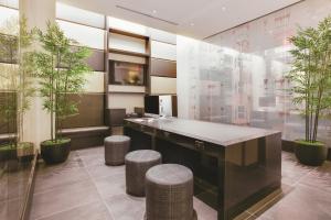 an office with a desk with stools and plants at The Hotel at Fifth Avenue in New York +63 photos