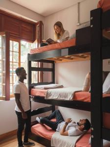 two people standing in a room with bunk beds at Hobi Hotel Boutique - Bela Vista - Prox a Av Paulista in São Paulo +55 photos