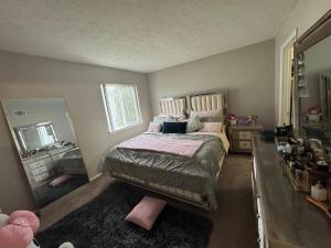 a bedroom with a bed and a large mirror at Comfort zone in Indianapolis