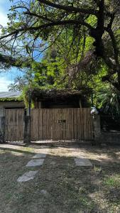 a wooden fence in front of a house at Casa Zorzal in Paso de la Patria