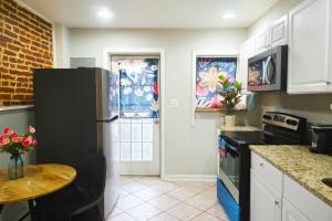 a kitchen with a black refrigerator and a table at Downtown 1BD APT, Walk to Stadiums, Free Parking in Baltimore