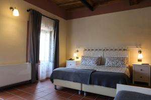 a bedroom with a bed and a large window at Tenuta Valtoppa in Sillavengo