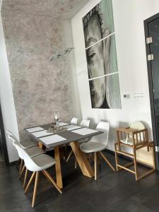a dining room with a table and chairs at Villa Kulacs in Veľký Meder