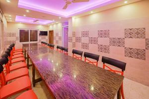 a conference room with a long table and chairs at Hotel O Blue Sagar in Puri +22 photos