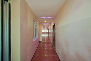 an empty hallway with a long corridor at Hotel O Blue Sagar in Puri