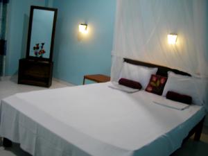 Letto o letti in una camera di Sigiri Lion Lodge