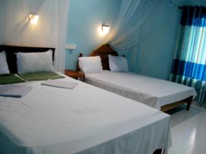Letto o letti in una camera di Sigiri Lion Lodge