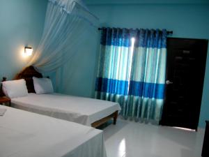 Letto o letti in una camera di Sigiri Lion Lodge