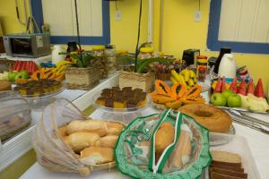 a table topped with lots of different types of food at Pousada Banzay in Paraty