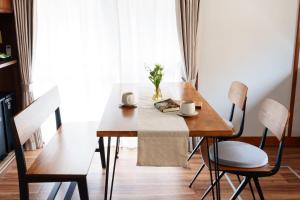 a dining room table with two chairs and a table and a tablewered at ふとの情景 Futo Nostalgia in Ito