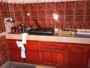 a kitchen with a stove and a counter top at Maison Ait alla tantan in Tan-Tan Plage +7 photos