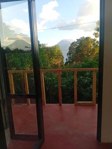 a view from a glass door of a balcony at Hostel Casa escondida in Santa Cruz La Laguna +81 photos