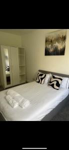 a bed with two pillows on it in a bedroom at Cosy Double room in house available with shared bathroom in Hurlet
