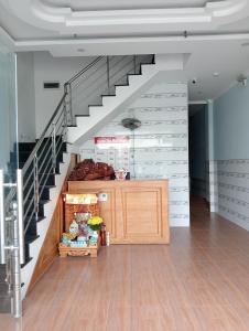 a room with a staircase with a wooden cabinet under it at Khách sạn Đạt Tiến Quân in Ấp Bình Hưng