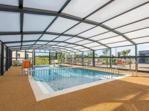 a swimming pool with a large glass ceiling at Chalet 3 chambres avec terrasse calme à Saint-Romain-de-Benet - FR-1-783-48 in Saint-Romain-de-Benet
