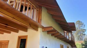 a house with wooden stairs on the side of it at Cabañas El Borrego in Mazamitla