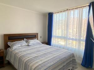 En eller flere senge i et værelse på DEPARTAMENTOS en PLAYA CAVANCHA